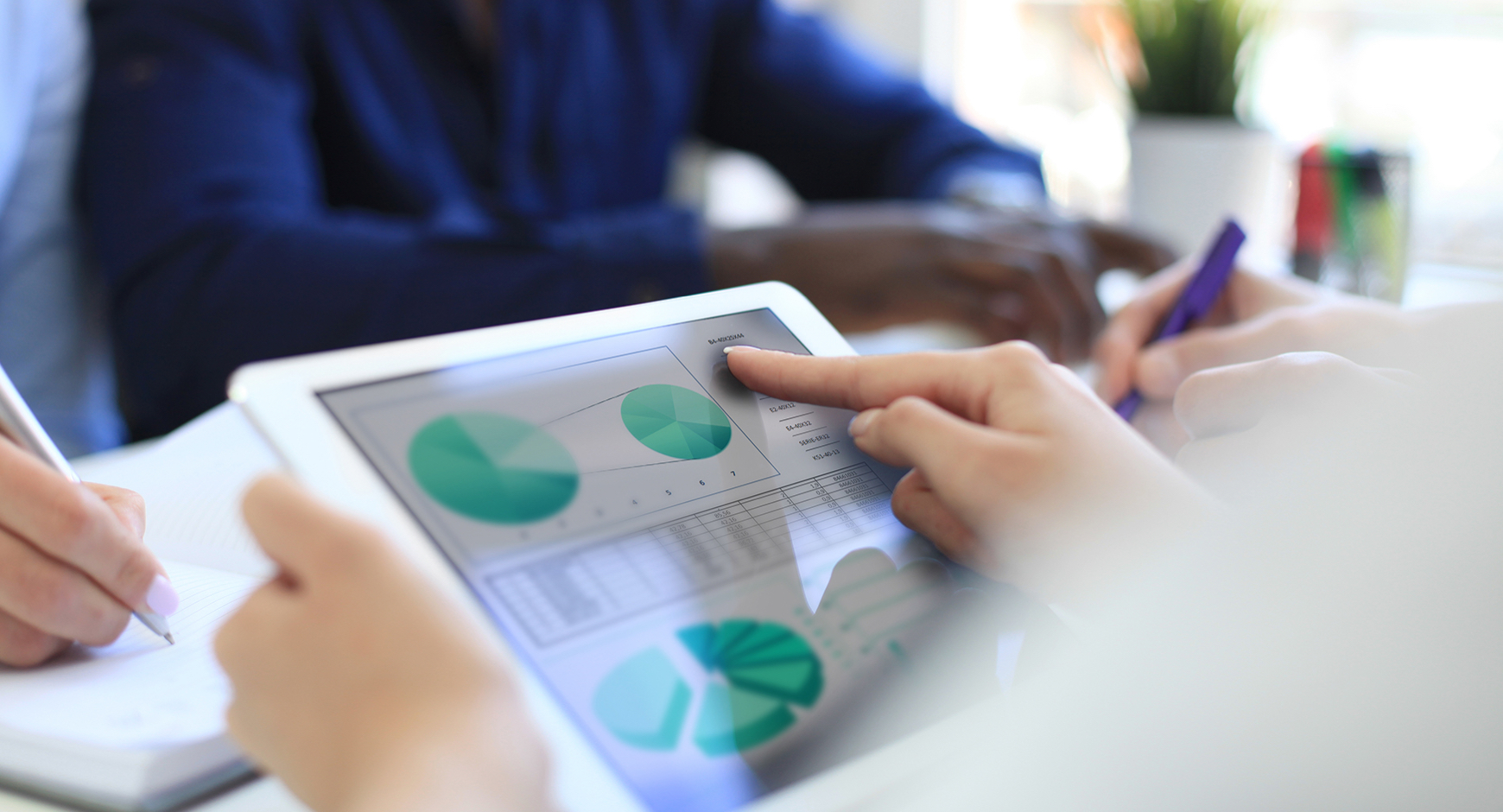 First person point of view shot of woman looking at pie chart on a tablet