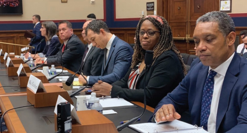 Federal employees sitting at desks in a court room